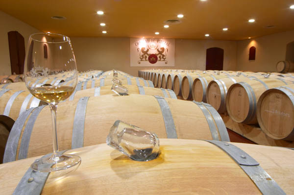 Barrels with white wine in the cellar