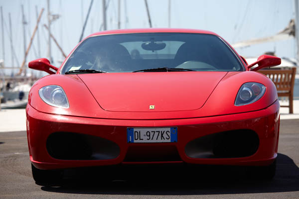 A red car in a parking lot