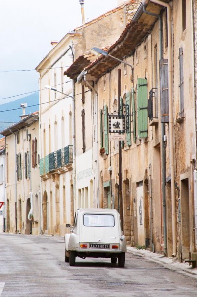 A street in a small French village with a 2CV Citroen