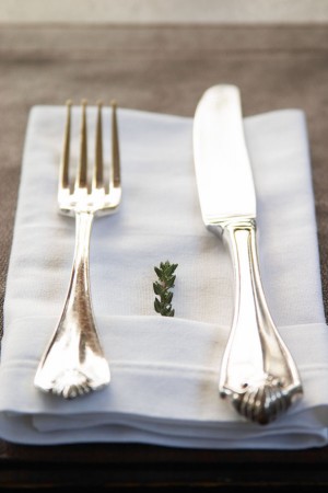 Knife, fork, napkin and a thyme twig