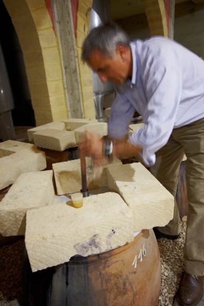 Giusto Occhipinti, COS, taking a wine sample from an amphora