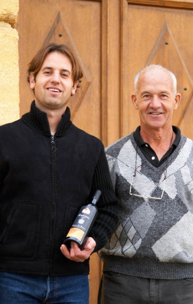 Philippe Viret owner and winemaker at Domaine Viret holding a bottle of cuvee Emergence and his father Alain