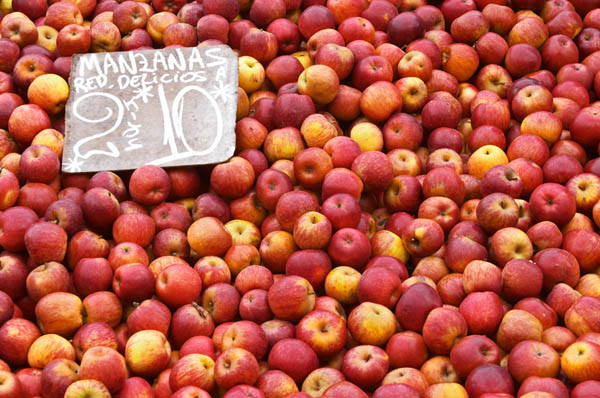 A market stall on a street market selling apples