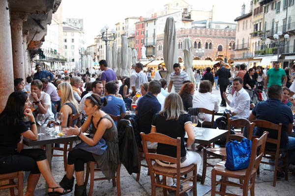 Cafe and wine bar with people on the Piazza delle Erbe in Verona