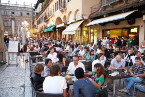 Cafe and wine bar with people on the Piazza delle Erbe in Verona