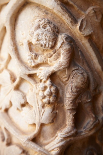 Sculpture on a pillar in a monastery of a wine harvest