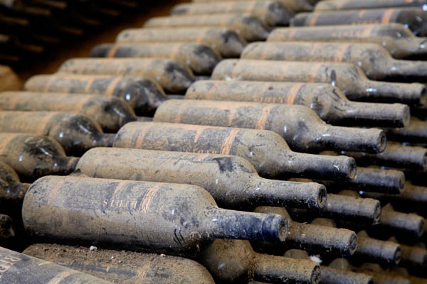 Wine bottles resting in the cellar at Valle dell'Acate