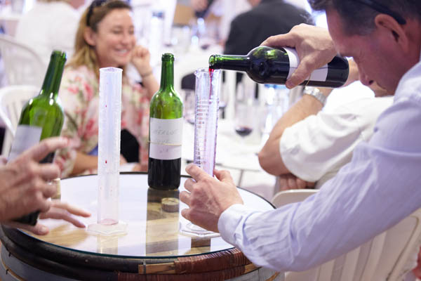 Carefully pouring wine in a measuring glass for a blend