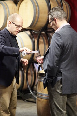 Carefully pouring wine in a measuring glass for a blend