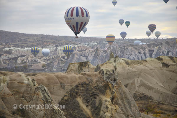 Balloons over the landscape in Cappadocia, Pigeon Valley, Turkey