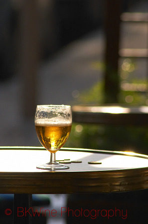 On a cafe table, a glass of beer