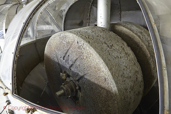 An olive crusher in traditional stones at an olive mill in Turkey