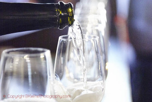 A glass of Italian bubbly wine being poured