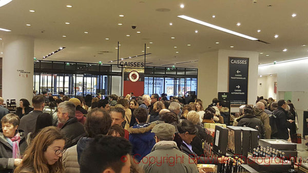 The checkout counter line at Le Bon Marche the day before Christmas