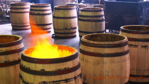 Toasting oak barrels with fire at a cooperage