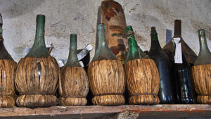 Old bottles of wine, fiasco model, in Tuscany