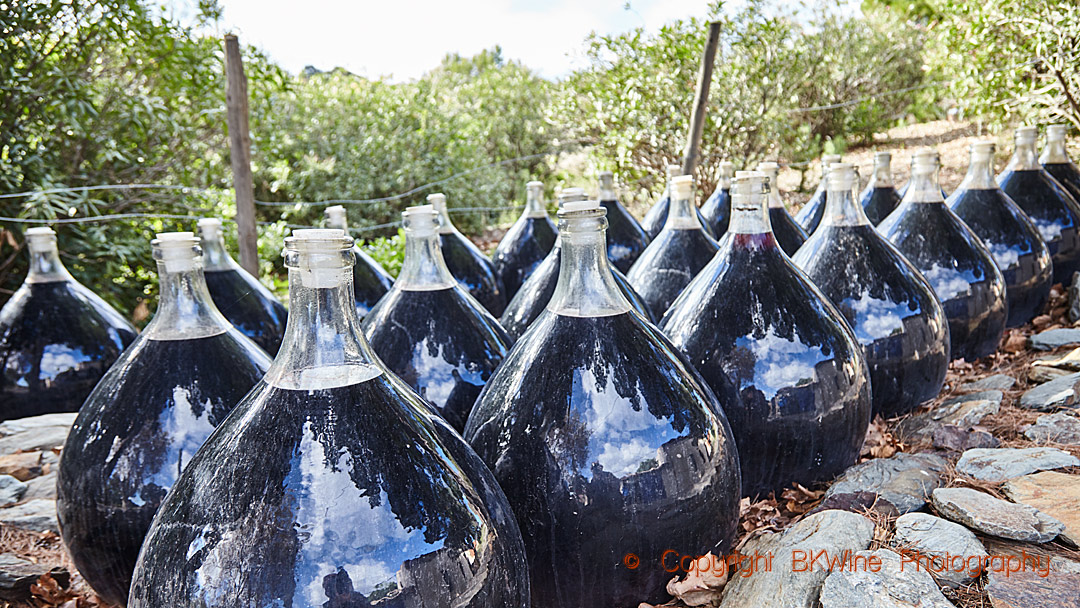 Demi-johns with rivesaltes wine maturing outside in the sunshine