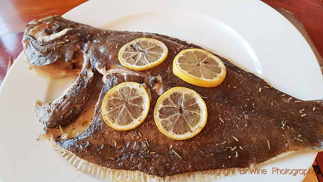 A barbue (brill) with lemons out of the oven