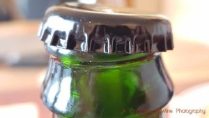 A crown cap, old-fashioned beer cap on a wine bottle