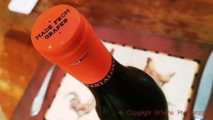 A bottle-neck capsule with “made from grapes” on a bottle of Testalonga El Bandito natural wine from South Africa