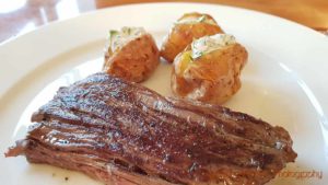 An onglet steak with baked potatoes with cream and herbs