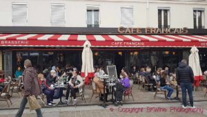 A café in Paris called Le Café Francais, with people sitting outside “en terrasse” the first day after covid closing