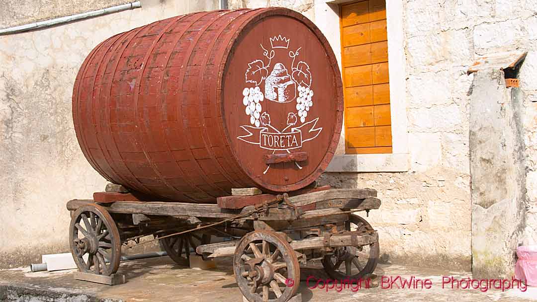 An old cart with a barrel to transport wine at the Toreta winery on Korcula Island in Croatia