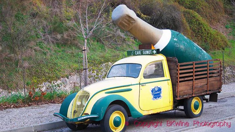 An old vintage car-lorry with a big bottle at Cave Guinot in Limoux in the Languedoc