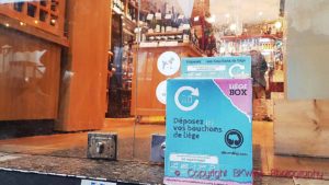 A cork collection box for recycling cork stoppers, outside a wine shop