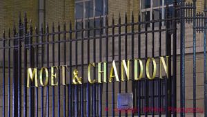 Moet & Chandon in golden letters on the fence outside the offices in Epernay, Champagne