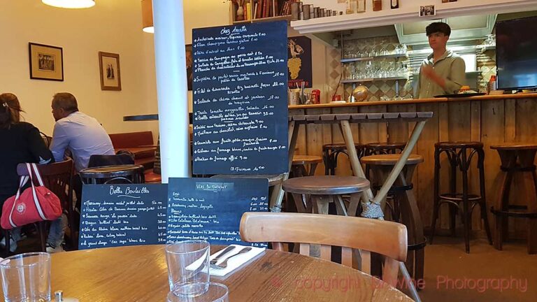 A small French (Paris) restaurant with the menu and wine list on chalk boards