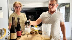 Pascal and Sandrine Lejeune of Champagne Pascal Lejeune pouring in the cellar