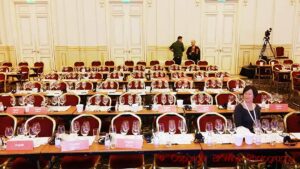 A room set up for a big wine tasting with glasses on the tables