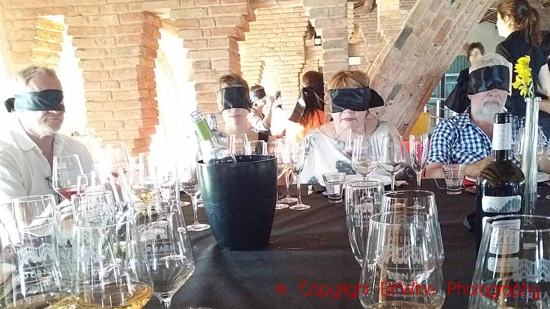 Wine tasters at a blind tasting with blindfolds