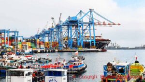 Cranes, ships, containers and fishing boats in the port of Valparaiso, Chile