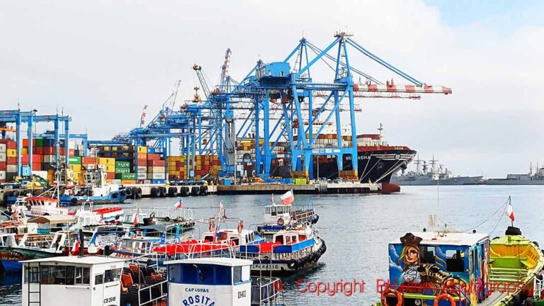 Cranes, ships, containers and fishing boats in the port of Valparaiso, Chile