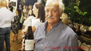 Tienie Louws, the father of the current owner-manager of Diemersdal Thys Louw, holding a bottle of Eight Rows Sauvignon Blanc