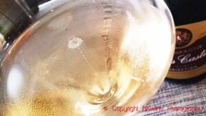 A glass of sparkling wine with bubbles rising to the surface
